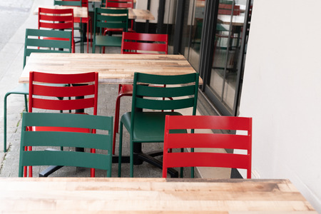 green and red chair with table in outdoor bar terraceの写真素材
