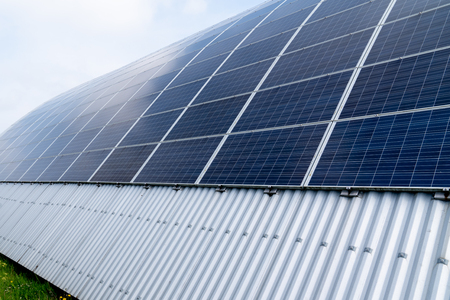 Solar panels panorama sun flare in round industrial buildingの写真素材