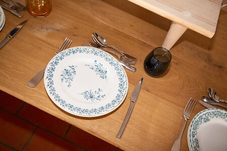 Served wooden dinner table with floral decorations