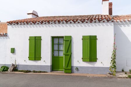 White house facade with green shutters blinds and door in Noirmoutier island Franceの写真素材