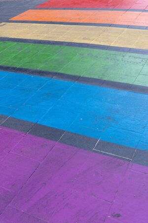Rainbow colored zebra LGBT pedestrian crossing on a street