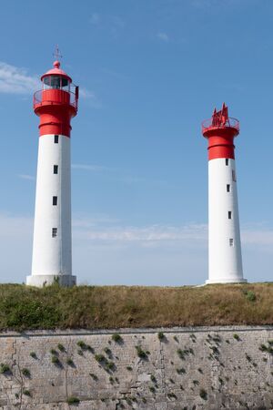 two red and white lighthouses and fortifications of the island of Aix Charente Franceの写真素材