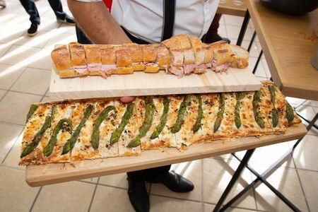 waiter holding platter to guests having appetizers at a party wedding receptionの写真素材