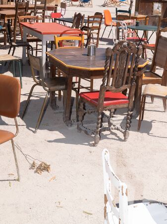 different vintage street tables and chairs in a cafe outdoor second handの写真素材