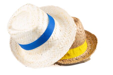 two straw hat with a blue yellow ribbon isolated on white backgroundの写真素材