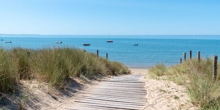 coastal area with sand beach grass entrance to Atlantic ocean in Ile de Noirmoutier France in web banner template headerの写真素材