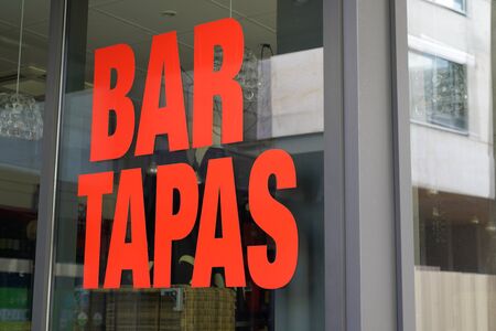 windows tapas bar sign restaurant on streetの写真素材