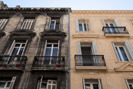 Difference between wash cleaned building house facade and a dirty one in town centerの写真素材