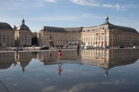 Bordeaux , Aquitaine / France - 10 30 2019 : Palais de la Bourse at Bordeaux child girl run in miroir d'eauのeditorial素材