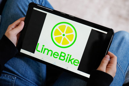 Bordeaux , Aquitaine / France - 11 25 2019 : tablet hand logo of LIME app rent bike e-Scooter rental electric scooter companyのeditorial素材