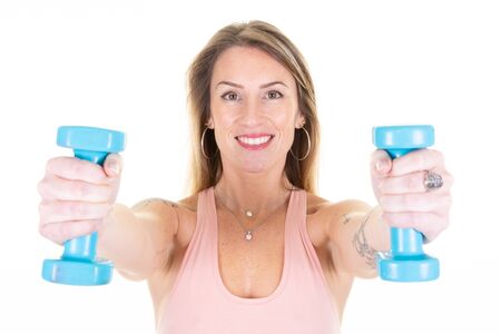 Attractive young fitness woman beauty holding dumbbells in studio shot white background