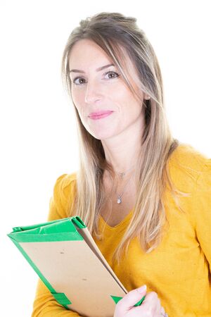 Happy female professional holding documents looking at camera Young business woman standing isolated over white backgroundの写真素材