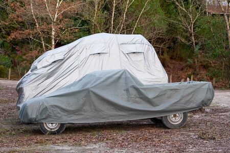 two Car underneath a car cover to protect against sun and dustの写真素材