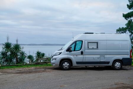 campervan rv parked on seaside in winter sunrise vanlife day in french coast in cap ferret village franceの写真素材