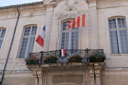 city hall cavaillon town with french and regional flagの写真素材