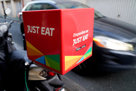 Bordeaux , Aquitaine / France -  01 04 2019 : Just Eat sign logo food restaurant home delivery company carrier scooter motorcycleのeditorial素材