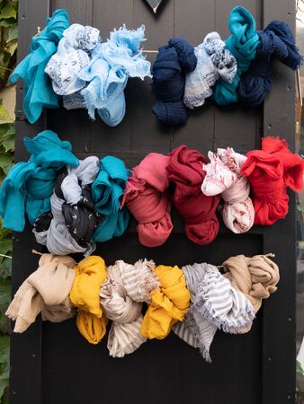 pattern of many women scarves colorful vibrant colors shop hanging on display in shopping street market storeの写真素材