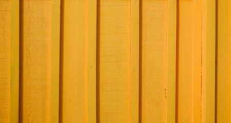 Vertical background of wooden planks with orange yellow wood paintの写真素材