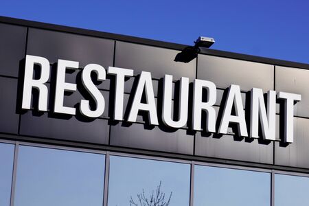 restaurant white text sign on black city street storefrontの写真素材