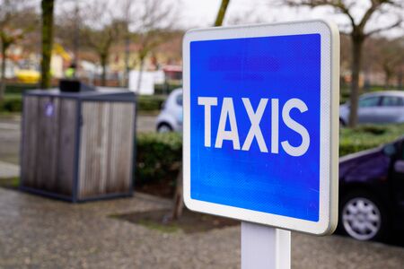 taxi blue sign service signage hanging on pole streetの写真素材