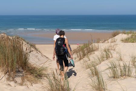 couple vacation women in access sand dune sea beach in Le Porge gironde france