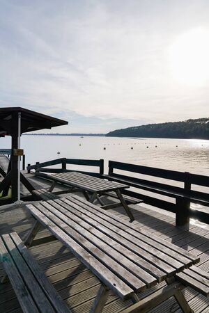 wooden table in wood terrace on lake in town Hourtin France