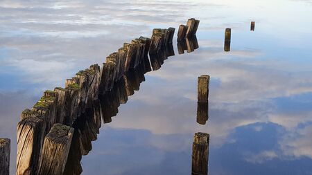 breaks waves on  Biscarrosse lake mirror image in blue water cloud sky reflection Franceの写真素材