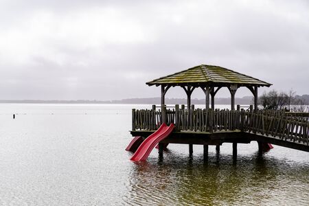 Maguide lake forest wood hut on wooden stilts on coast beach water in cloudy dayの写真素材