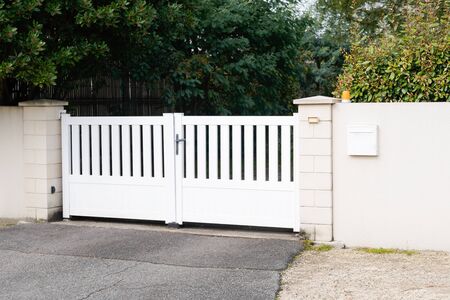 modern gate in white aluminum with blades of suburbs houseの写真素材