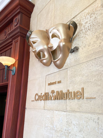 Marne-la-VallÃ©e , paris / France - 03 03 2020 : Credit mutuel office sign logo bank agency facade with happy gold venetian mask in golden street signageのeditorial素材