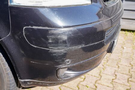 van bumper with scratch damaged broken car scratched paint in accident collision streetの写真素材