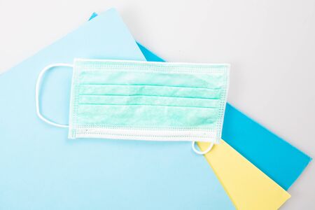 Coronavirus folder with blue protective mask on business paperwork covid-19の写真素材