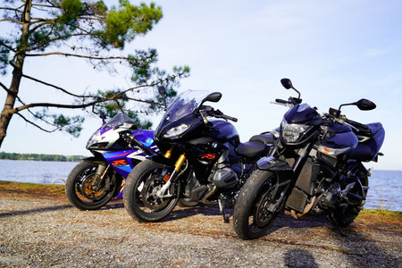 Bordeaux , Aquitaine / France - 03 03 2020 : three motorbikes parked by lake  bmw and suzuki brand