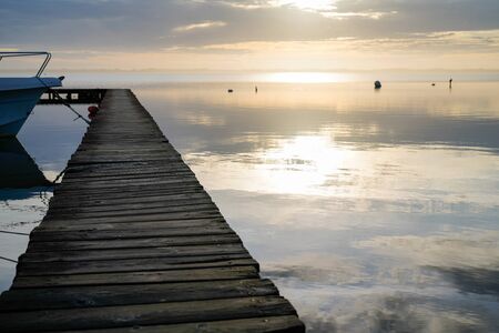 Biscarrosse lake sunset wooden ponton on water for boat fishing