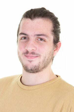 Young long haired bearded man with tied hair smilingの写真素材