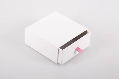Opened cardboard sliding box with drawer pink ribbonの写真素材