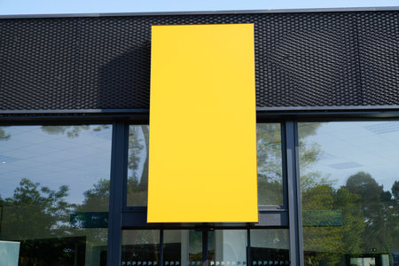vertical yellow store signage on shop front streetのeditorial素材
