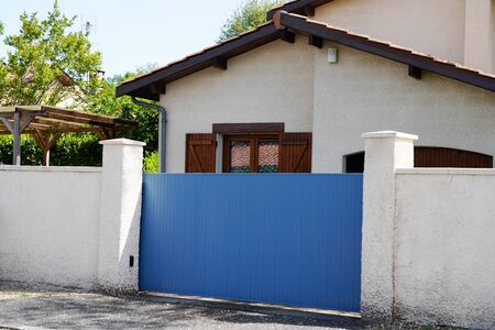 classic blue door metal home gate at entrance of house portalの写真素材