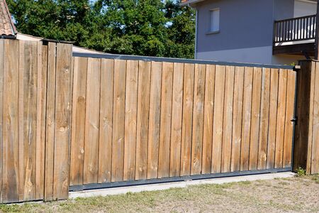 Brown portal natural wooden gate of private house in suburb