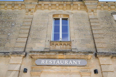 restaurant text sign with windows on old french building in city streetのeditorial素材