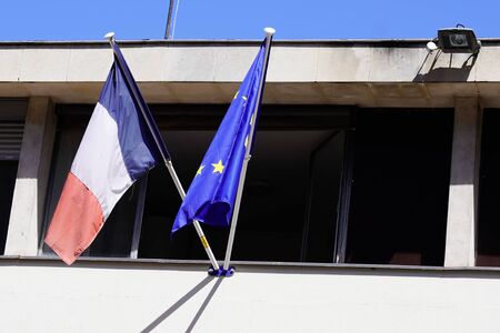 french and EU European Union flags on window of city hallの写真素材