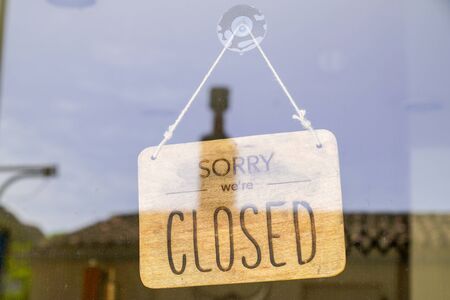 wooden sorry we are closed or open sign board wood on windows shop restaurant cafe store signboardの写真素材