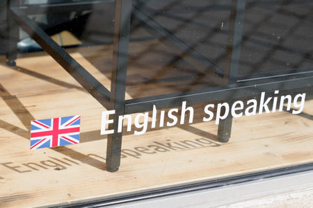 uk Sticker with text english speaking on windows store for tourist customer during vacation holidaysのeditorial素材