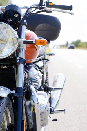 Motorcycle orange and vintage parked on road