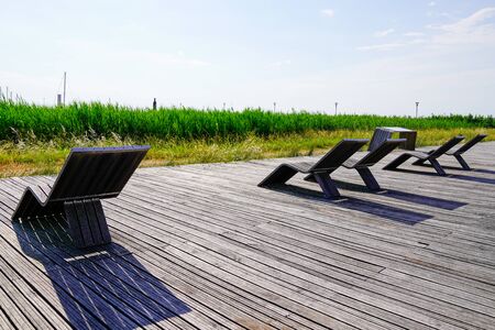 wooden relax armchair on the quays of Pauillac in Girondeの写真素材