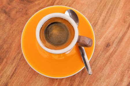 Cup of coffee on wooden background in top view and flat layの写真素材