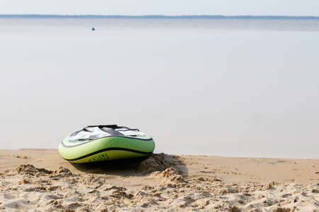 sup paddle board lying on sand near beach lake water on the lakeside