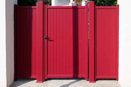 red small modern metal aluminum gate of suburb house