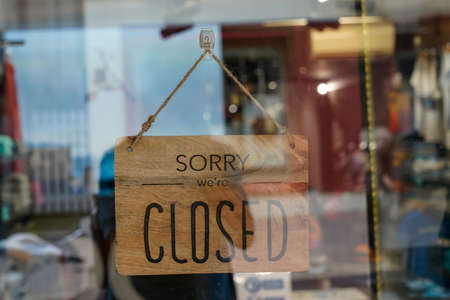 wooden sorry we are closed sign board wood on windows shop restaurant cafe store signboardの写真素材