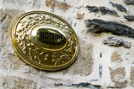 Bordeaux, Aquitaine / France - 08 16 2020: Notaire sign and text on golden plate on wall entrance to...